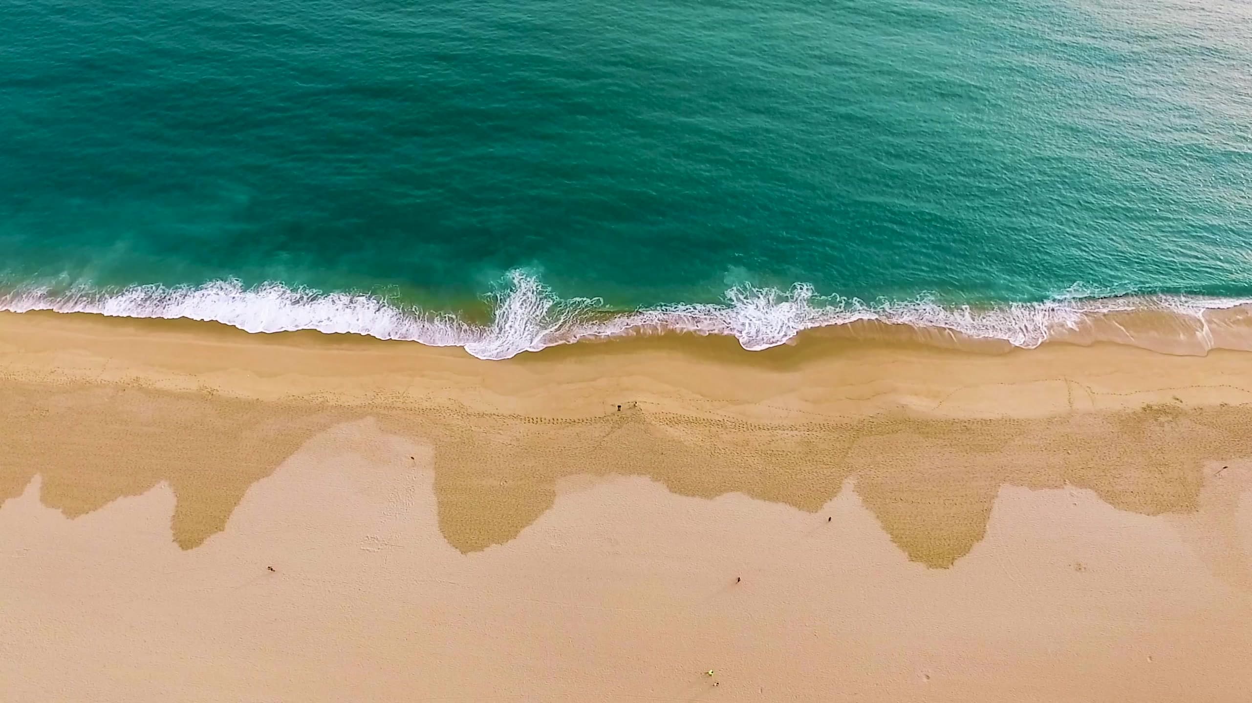 Aerial view of waves breaking on a shoreline